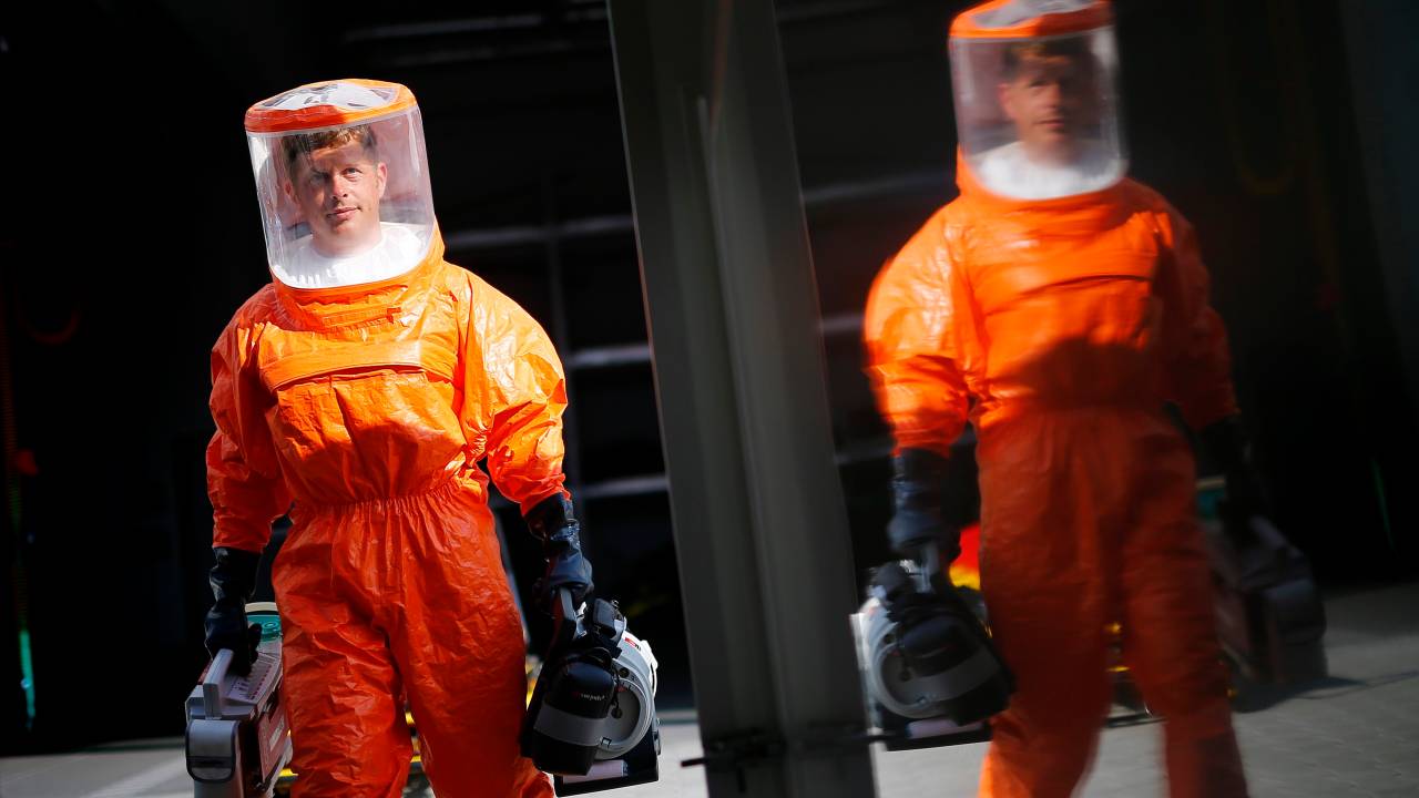 Paramédicos com equipamentos de proteção contra o vírus Ebola são vistos em Frankfurt, na Alemanha. O país está enviando ajuda humanitária a cinco regiões da África que sofrem com os surtos da doença