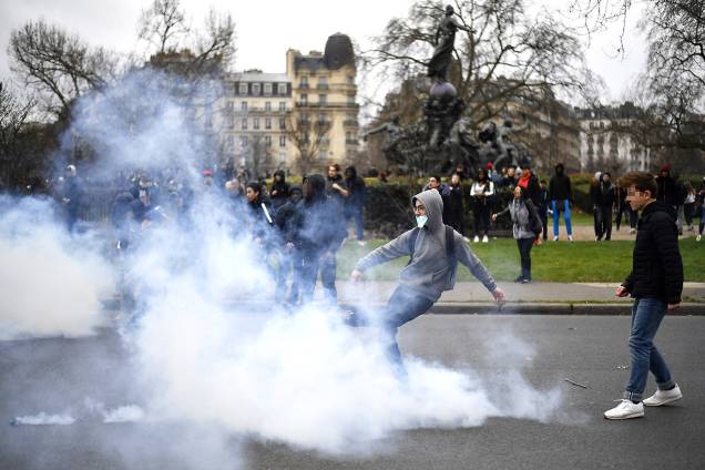 Manifestante chuta lata de gás lacrimogêneo durante protesto contra a violência policial na Place de La Nation, em Paris, França, que ocorreu após o caso "Theo", um estudante que alega ter sido estuprado por policiais - 23/02/2017 Manifestante chuta lata de gás lacrimogêneo durante protesto contra a violência policial na Place de La Nation, em Paris, França, que ocorreu após o caso "Theo", um estudante que alega ter sido estuprado por policiais - 23/02/2017