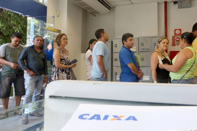 Pessoas se dirigem as agências da Caixa Econômica Federal para obter informações sobre FGTS Pessoas se dirigem as agências da Caixa Econômica Federal para obter informações sobre FGTS