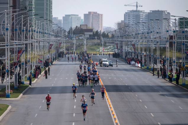 Corredores atravessam a rua dos Cientistas de Mirae durante a maratona de Pyongyang, no Coreia do Norte - 09/04/2017 Corredores atravessam a rua dos Cientistas de Mirae durante a maratona de Pyongyang, no Coreia do Norte - 09/04/2017