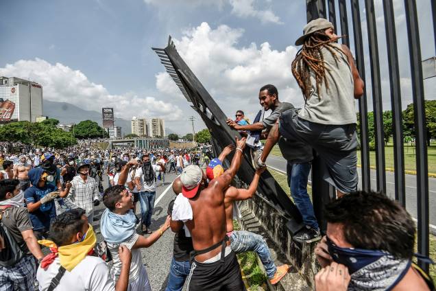 Manifestantes tentam derrubar uma cerca na base aérea de La Carlota durante uma manifestação contra o presidente venezuelano, Nicolas Maduro, em Caracas - 19/04/2017 Manifestantes tentam derrubar uma cerca na base aérea de La Carlota durante uma manifestação contra o presidente venezuelano, Nicolas Maduro, em Caracas - 19/04/2017