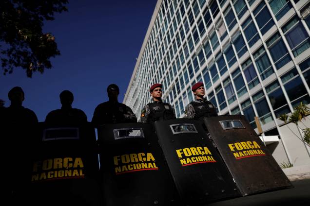 Policiais da Força Nacional patrulham uma entrada da Esplanada dos Ministérios antes do protesto contra as reformas econômicas propostas pelo presidente Michel Temer, em uma greve geral nacional organizada por sindicatos contra uma revisão das regras trabalhistas e de pensão em Brasília. Policiais da Força Nacional patrulham uma entrada da Esplanada dos Ministérios antes do protesto contra as reformas econômicas propostas pelo presidente Michel Temer, em uma greve geral nacional organizada por sindicatos contra uma revisão das regras trabalhistas e de pensão em Brasília.