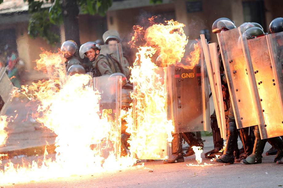 Forças de segurança venezuelanas pegam fogo durante protesto contra o presidente Nicolás Maduro, em Caracas - 27/07/2017