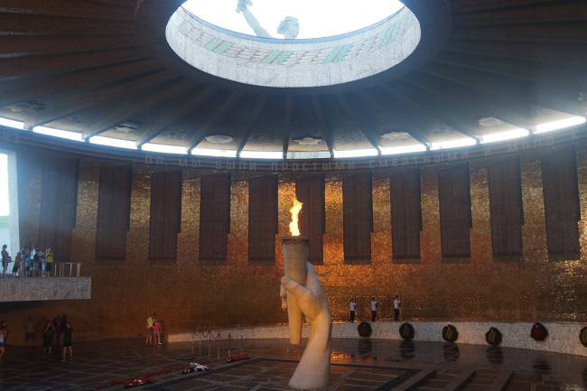 Panteão do fogo eterno em homenagem aos heróis da Batalha de Stalingrado; através da abóbada vazada, é possível ver a estátua da Pátria-Mãe Panteão do fogo eterno em homenagem aos heróis da Batalha de Stalingrado; através da abóbada vazada, é possível ver a estátua da Pátria-Mãe