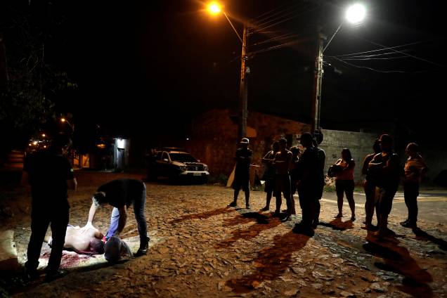 Técnicos forenses inspecionam o cadáver de um homem não identificado nos arredores de Fortaleza - 11/01/2019 Técnicos forenses inspecionam o cadáver de um homem não identificado nos arredores de Fortaleza - 11/01/2019