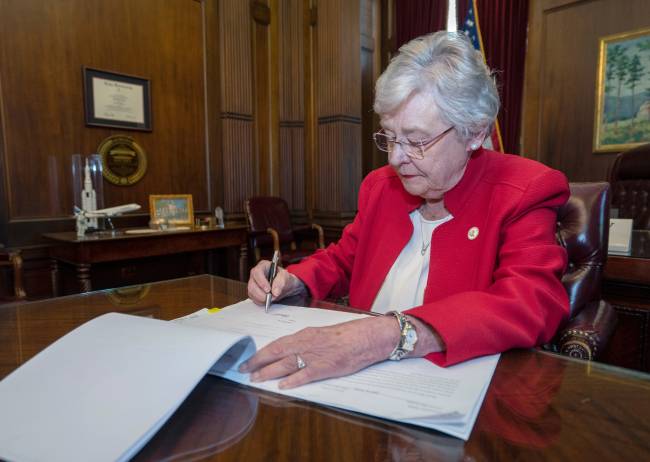 Handout photo of Alabama Governor Kay Ivey signing into law the Alabama Human Life Protection Act in Montgomery Handout photo of Alabama Governor Kay Ivey signing into law the Alabama Human Life Protection Act in Montgomery