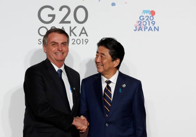 Brazilian President Jair Bolsonaro is welcomed by Japanese Prime Minister Shinzo Abe upon his arrival for a welcome and family photo session at G20 leaders summit in Osaka Brazilian President Jair Bolsonaro is welcomed by Japanese Prime Minister Shinzo Abe upon his arrival for a welcome and family photo session at G20 leaders summit in Osaka