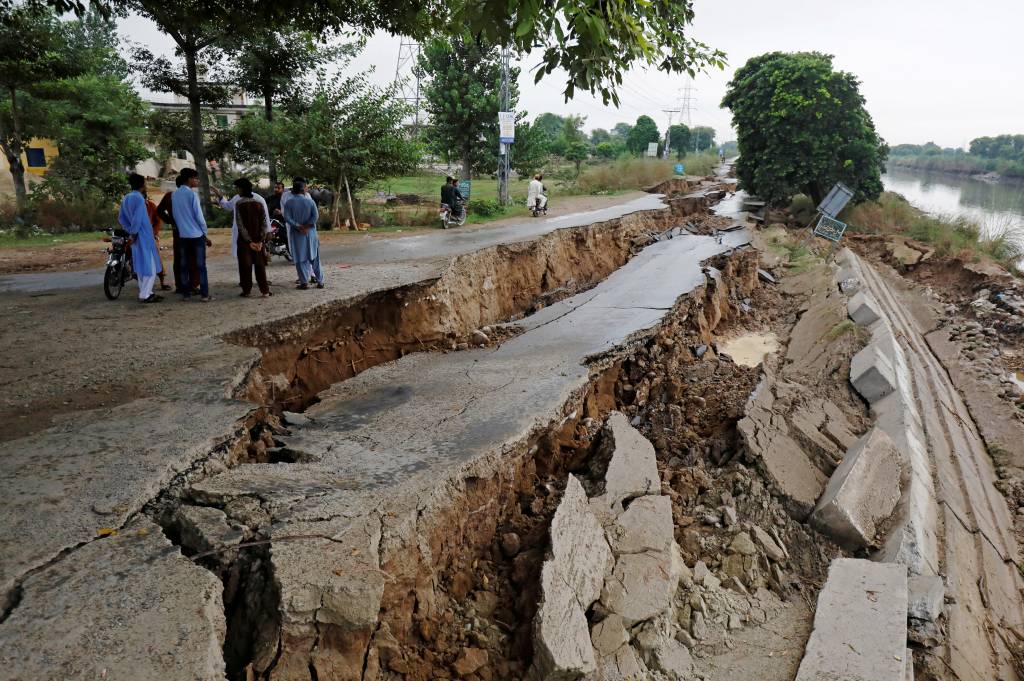 People gather near a damaged road after an earthquake in Mirpur People gather near a damaged road after an earthquake in Mirpur