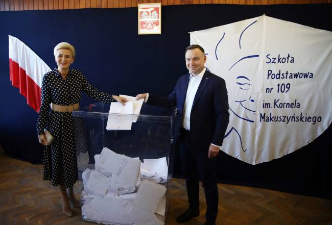 Poland’s President Andrzej Duda and his wife Agata Kornhauser-Duda cast their votes during parliamentary election at a polling station in Krakow