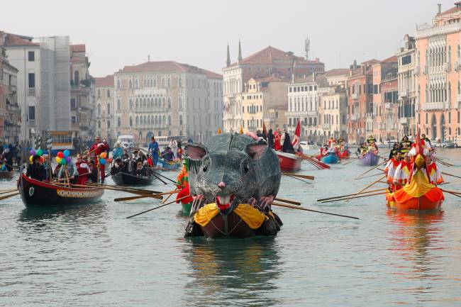 Venetians row during the masquerade parade on the Grand Canal during the Carnival in Venice Venetians row during the masquerade parade on the Grand Canal during the Carnival in Venice