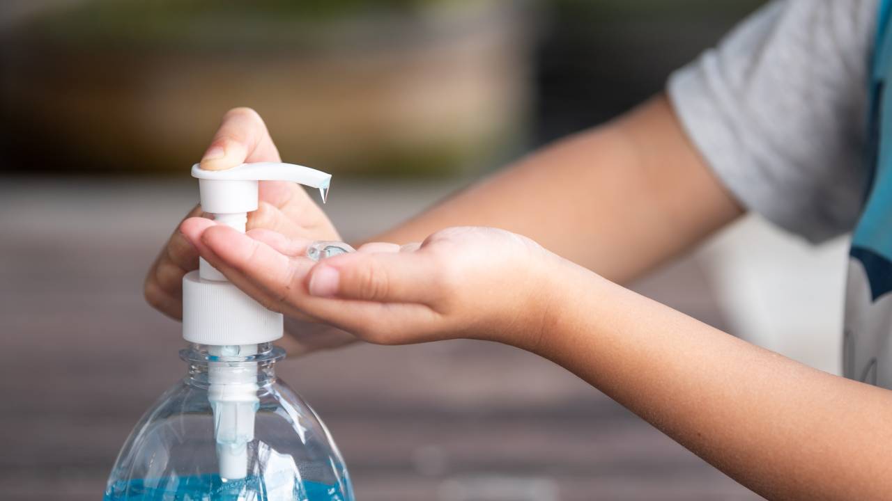 Child Hands Using Wash Hand Sanitizer Gel Pump Dispenser, Selected Focus