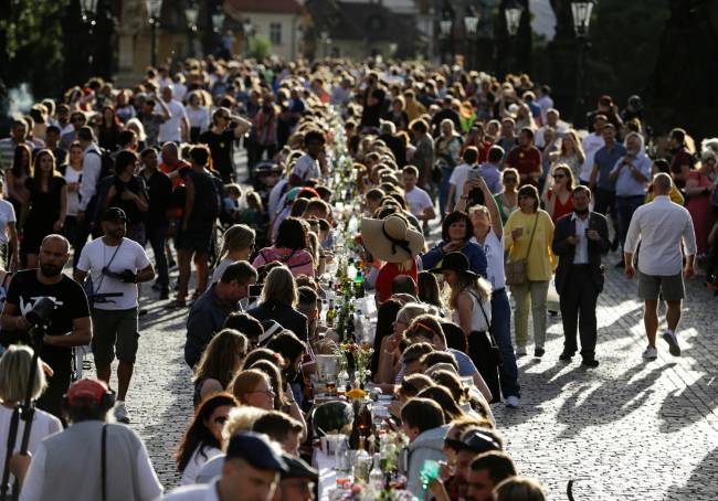 Residents dine at the medieval Charles Bridge in Prague Residents dine at the medieval Charles Bridge in Prague