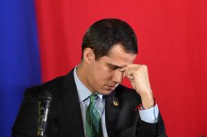 FILES-VENEZUELA-CRISIS-PARLIAMENT-GUAIDO (FILES) In this file photo taken on February 18, 2020 Venezuelan opposition leader and self-proclaimed acting president Juan Guaido gestures during a plenary session of the National Assembly at the San Antonio municipal theatre in San Antonio de Los Altos south of Caracas. - A new Venezuelan parliament will be sworn in on January 5, 2021 with the party of President Nicolas Maduro now in almost complete control and the main thorn in his side, Western-backed opposition leader Juan Guaido, out in the political cold. (Photo by Federico PARRA / AFP)