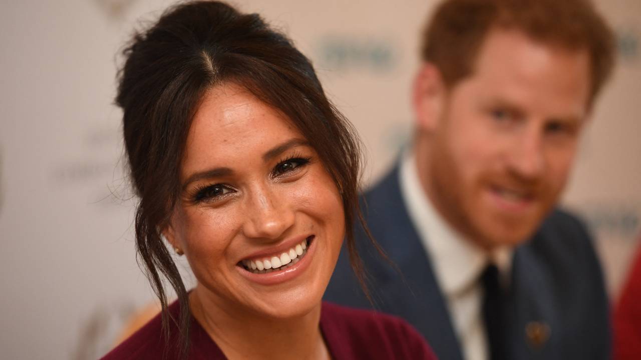 (FILES) In this file photo taken on October 25, 2019 Britain's Prince Harry, Duke of Sussex (R) and Meghan, Duchess of Sussex attend a roundtable discussion on gender equality with The Queens Commonwealth Trust (QCT) and One Young World at Windsor Castle in Windsor. - Queen Elizabeth II is saddened by the challenges faced by her grandson Prince Harry and his wife Meghan, and takes their allegations of racism in the royal family seriously, Buckingham Palace said on March 9, 2021. "The whole family is saddened to learn the full extent of how challenging the last few years have been for Harry and Meghan. The issues raised, particularly that of race, are concerning," the palace said in a statement released on the queen's behalf. (Photo by Jeremy Selwyn / POOL / AFP).