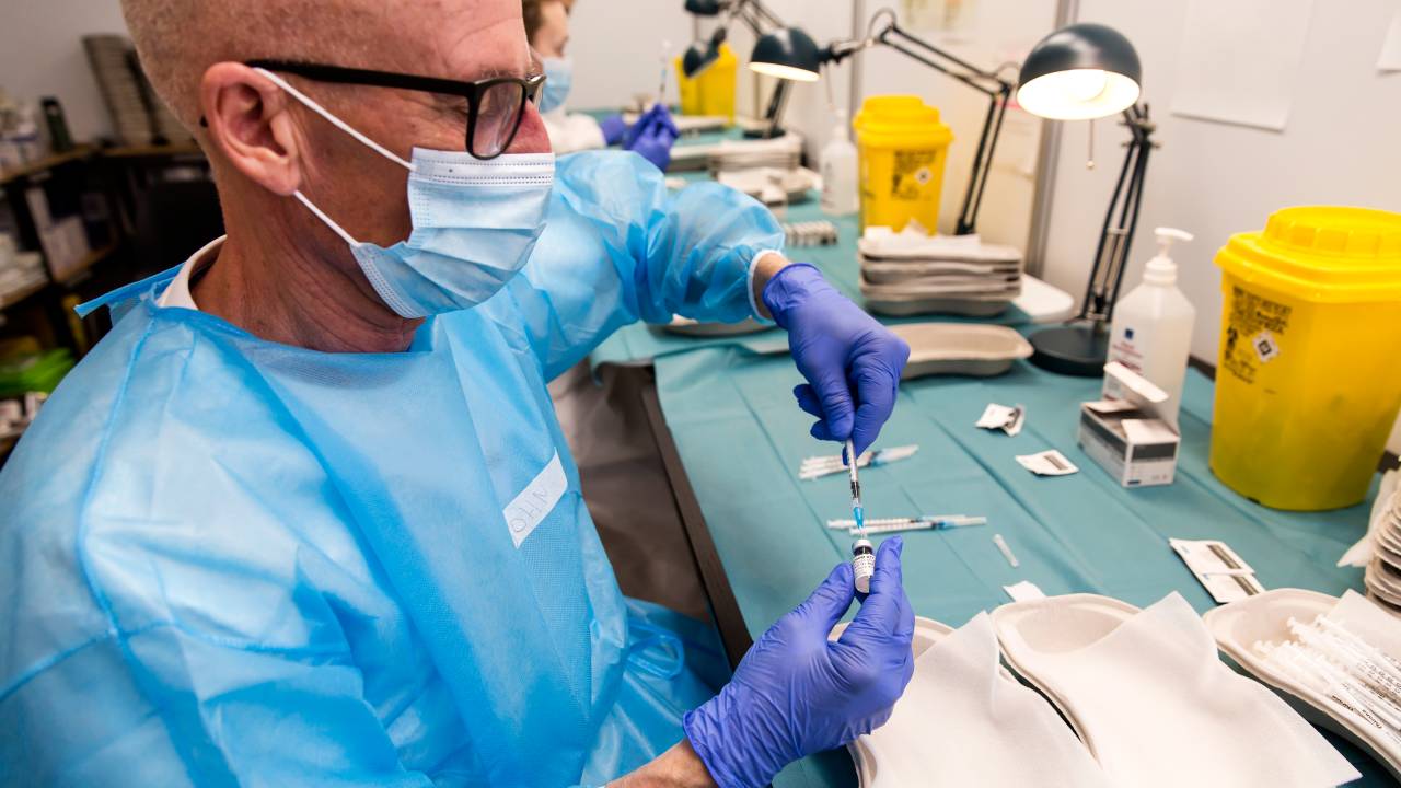 COPENHAGEN, DENMARK - MARCH 18: Health personnel are preparing injection syringes with Covid-19 vaccine from Pfizer at the Bella Center on March 18, 2021 in Copenhagen, Denmark. At this vaccination center the physical capacity is at 6.000 vaccines per day, but due to a lack of vaccines they take in around 2.500 per day. The country of 5.8 million has administered around 850,000 doses of covid-19 vaccine, or enough to cover 7.3 percent of the population with a two-dose vaccine. In terms of percentages of the population tested positive the share is at 0,26% on March 18. (Photo by Ole Jensen/Getty Images)