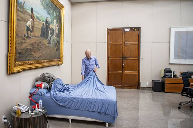O prefeito arruma a cama que instalou na sede da prefeitura durante a pandemia do novo coronavírus - O prefeito arruma a cama que instalou na sede da prefeitura durante a pandemia do novo coronavírus -