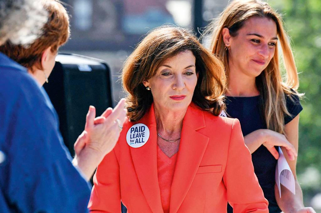AP21215776419095 Lt. Gov. Kathy Hochul, center, joins advocates for paid family and medical leave for all working people during a stop on the Paid Leave for All's national bus tour on Tuesday, Aug. 3, 2021, in Albany N.Y. New York Gov. Andrew Cuomo faced mounting pressure Tuesday to resign, including from President Joe Biden and other onetime Democratic allies, after an investigation found he sexually harassed nearly a dozen women and worked to retaliate against one of his accusers. Hochul, who would succeed Cuomo if he is removed or resigns, called the behavior detailed in the report