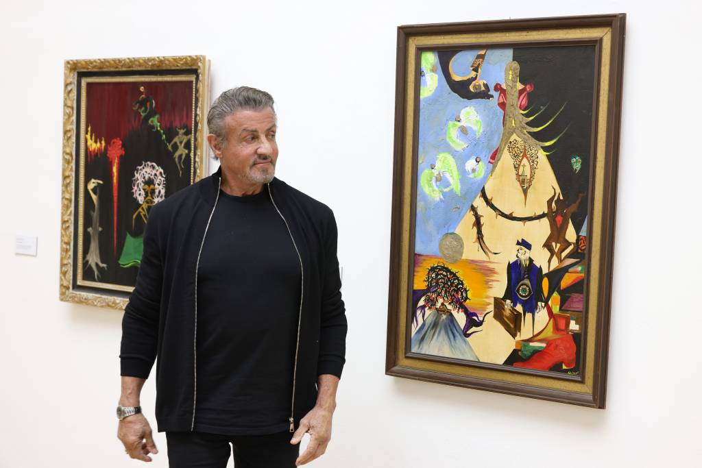 “Sylvester Stallone – Retrospektive zum 75. Geburtstag” Exhibition Opening In Hagen HAGEN, GERMANY - DECEMBER 03: Sylvester Stallone reviews his painting during the opening of the exhibition