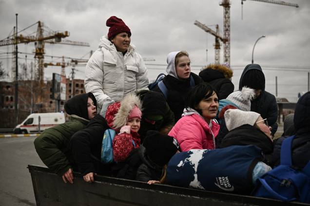 Uma criança observa moradores evacuando a cidade de Irpin durante bombardeios na Ucrânia - Uma criança observa moradores evacuando a cidade de Irpin durante bombardeios na Ucrânia -