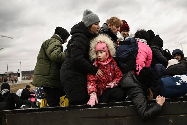 Uma criança observa moradores evacuando a cidade de Irpin, a noroeste de Kiev - Uma criança observa moradores evacuando a cidade de Irpin, a noroeste de Kiev -