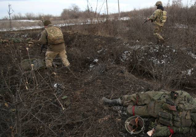 Soldado das Forças Militares Ucranianas passam por um corpo, após combates contra tropas russas e separatistas apoiados pela Rússia perto da vila de Zolote, na região de Lugansk - Soldado das Forças Militares Ucranianas passam por um corpo, após combates contra tropas russas e separatistas apoiados pela Rússia perto da vila de Zolote, na região de Lugansk -