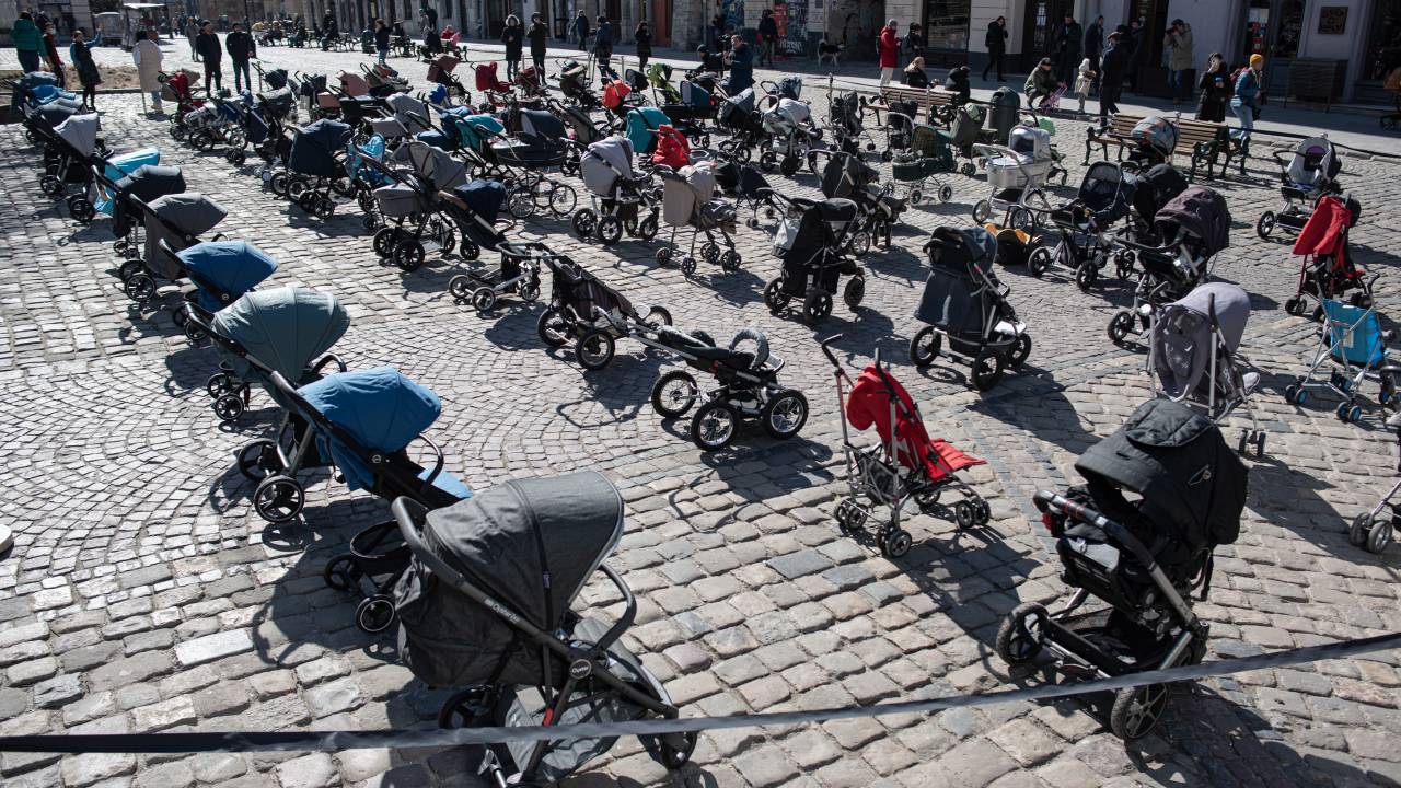 LVIV, UKRAINE - MARCH 18: 109 empty strollers are placed outside the Lviv city council during an action to highlight the number of children killed in the ongoing Russian invasion of Ukraine, on March 18, 2022 in Lviv, Ukraine. Lviv has served as a stopover and shelter for the millions of Ukrainians fleeing the Russian invasion, either to the safety of nearby countries or the relative security of western Ukraine. (Photo by Alexey Furman/Getty Images)