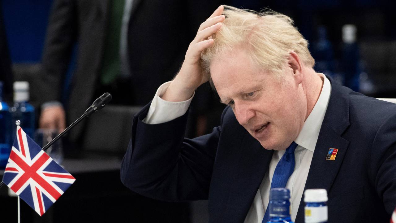 British Prime Minister Boris Johnson waits for the start of the second plenary session of the NATO summit at the Ifema Congress Centre in Madrid, on June 29, 2022. (Photo by Eliot BLONDET / POOL / AFP)