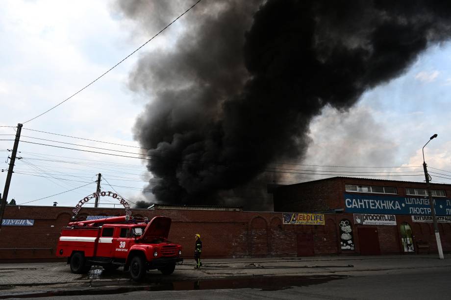 Bombeiros trabalham para controlar as chamas no mercado central de Sloviansk em 5 de julho de 2022, após um suposto ataque com mísseis em meio à invasão russa da Ucrânia.