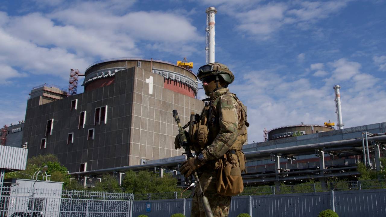 (FILES) In this file photo taken on May 1, 2022, A Russian serviceman patrols the territory of the Zaporizhzhia Nuclear Power Station in Energodar. - Kyiv on August 8, 2022, called for the establishment of a demilitarised zone around the nuclear power station in east Ukraine, where recent fighting with Russian forces has raised fears of a nuclear accident. The Kremlin on August 8, 2022, accused Ukrainian forces of firing on the Zaporizhzhia atomic power plant, warning of potential "catastrophic consequences" for Europe. *EDITOR'S NOTE: This picture was taken during a media trip organised by the Russian army.* (Photo by Andrey BORODULIN / AFP)