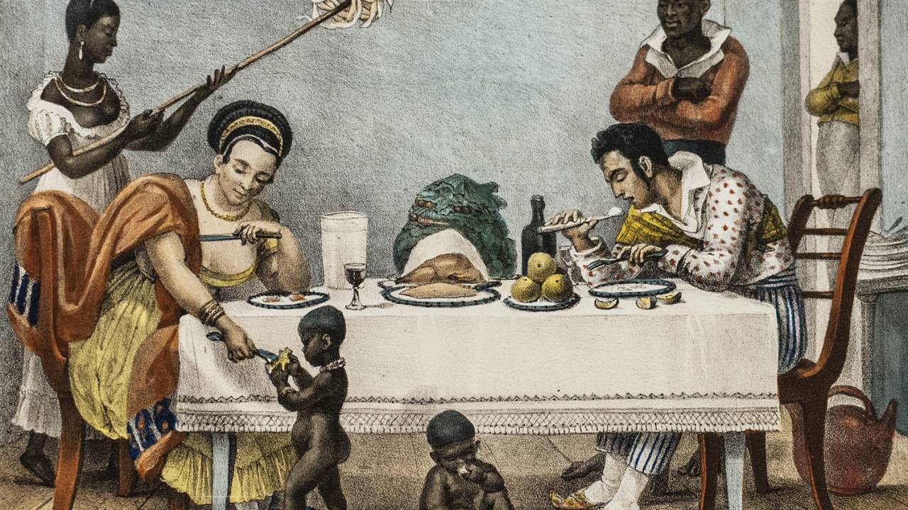 EM FAMÍLIA - Uma cena típica de refeição no Rio de Janeiro: entre frutas, mandioca e cativos escravizados -