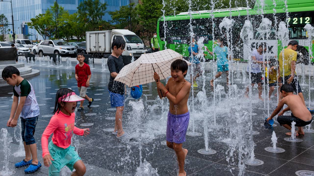 Children play in the Myeongnyang fountain in Gwanghwamun Square on August 17, 2022 in Seoul, South Korea. (Photo by Chris Jung/NurPhoto via Getty Images)