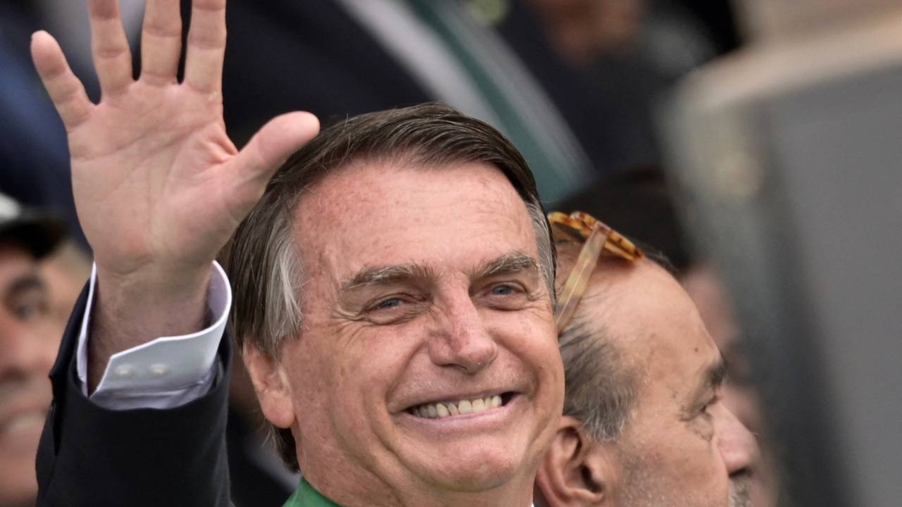 Brazilian President Jair Bolsonaro waves during a military parade to mark Brazil's 200th anniversary of independence in Brasilia, on September 7, 2022. (Photo by EVARISTO SA / AFP)