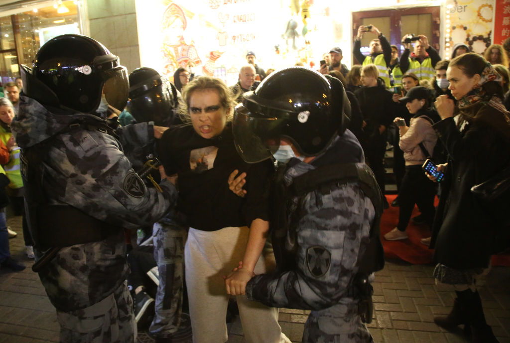 MOSCOW, RUSSIA - SEPTEMBER 21: (RUSSIA OUT) Russian Police officers detain detain a female protester during an unsanctioned protest rally at Arbat street on September 21, 2022, in Moscow, Russia. More than 500 people in Russian cities were detained during protest rallies against the mobilization for war against Ukraine, announced by President Putin on Wednesday. (Photo by Contributor/Getty Images)