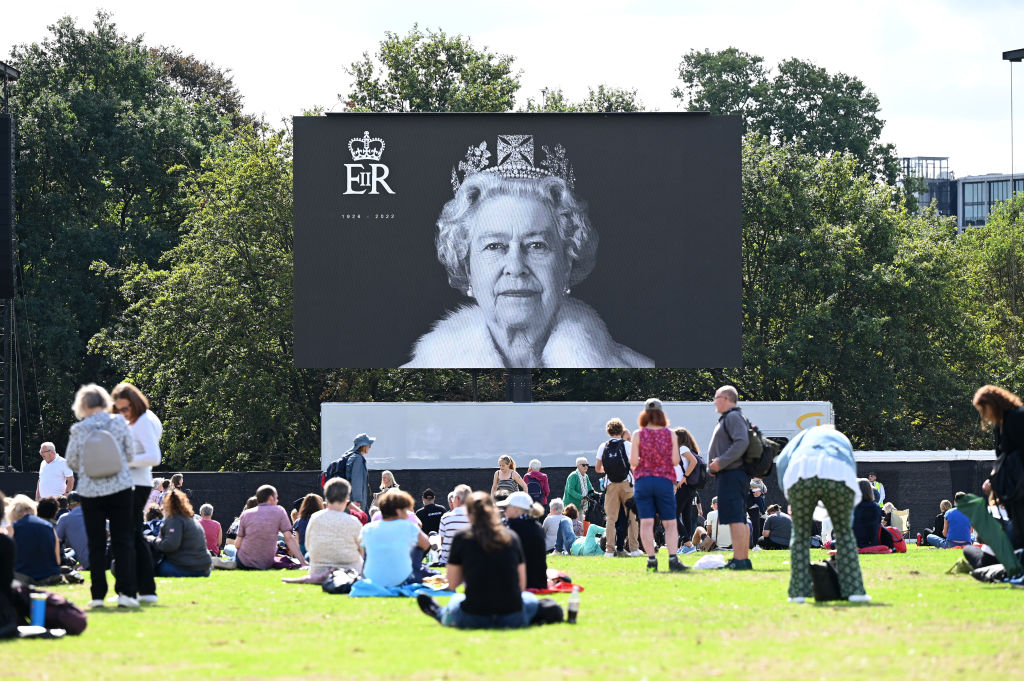 LONDON, ENGLAND - SEPTEMBER 14: Mourners gather to watch the procession for the Lying-in State of Queen Elizabeth II at the Hyde Park screening site on September 14, 2022 in London, England. Queen Elizabeth II's coffin is taken in procession on a Gun Carriage of The King's Troop Royal Horse Artillery from Buckingham Palace to Westminster Hall where she will lay in state until the early morning of her funeral. Queen Elizabeth II died at Balmoral Castle in Scotland on September 8, 2022, and is succeeded by her eldest son, King Charles III. (Photo by Stuart C. Wilson/Getty Images)
