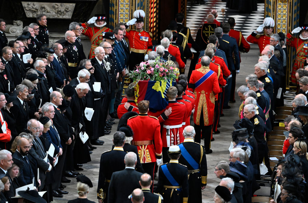 LONDON, ENGLAND - SEPTEMBER 19: The coffin of Queen Elizabeth II with the Imperial State Crown resting on top is carried by the Bearer Party into Westminster Abbey during the State Funeral of Queen Elizabeth II on September 19, 2022 in London, England. Elizabeth Alexandra Mary Windsor was born in Bruton Street, Mayfair, London on 21 April 1926. She married Prince Philip in 1947 and ascended the throne of the United Kingdom and Commonwealth on 6 February 1952 after the death of her Father, King George VI. Queen Elizabeth II died at Balmoral Castle in Scotland on September 8, 2022, and is succeeded by her eldest son, King Charles III. (Photo by Gareth Cattermole/Getty Images)