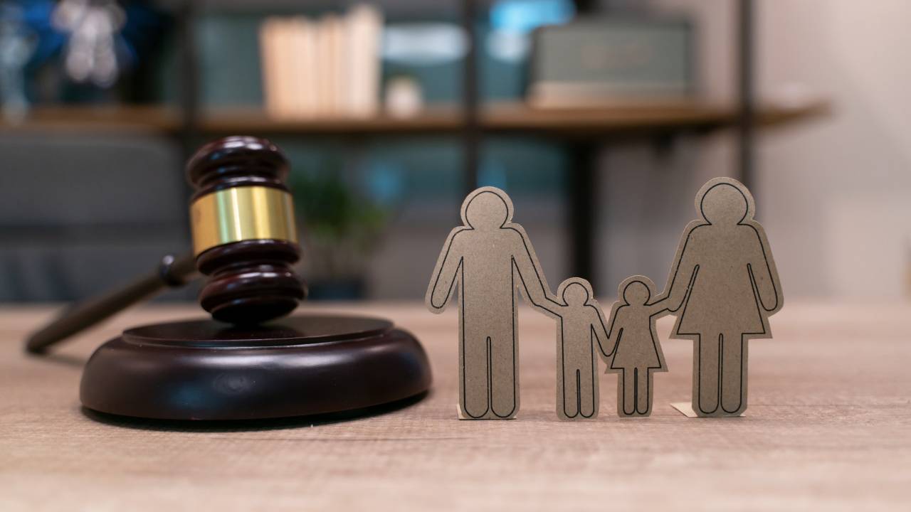 aper people chain, books and judge's gavel. Law, family politics and marriage legalization.