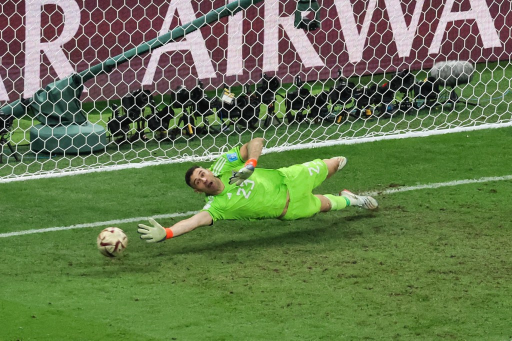 Argentina's goalkeeper #23 Emiliano Martinez deflects a shot fron France's midfielder #08 Aurelien Tchouameni during penalty shootouts during the Qatar 2022 World Cup final football match between Argentina and France at Lusail Stadium in Lusail, north of Doha on December 18, 2022. (Photo by JACK GUEZ / AFP)
