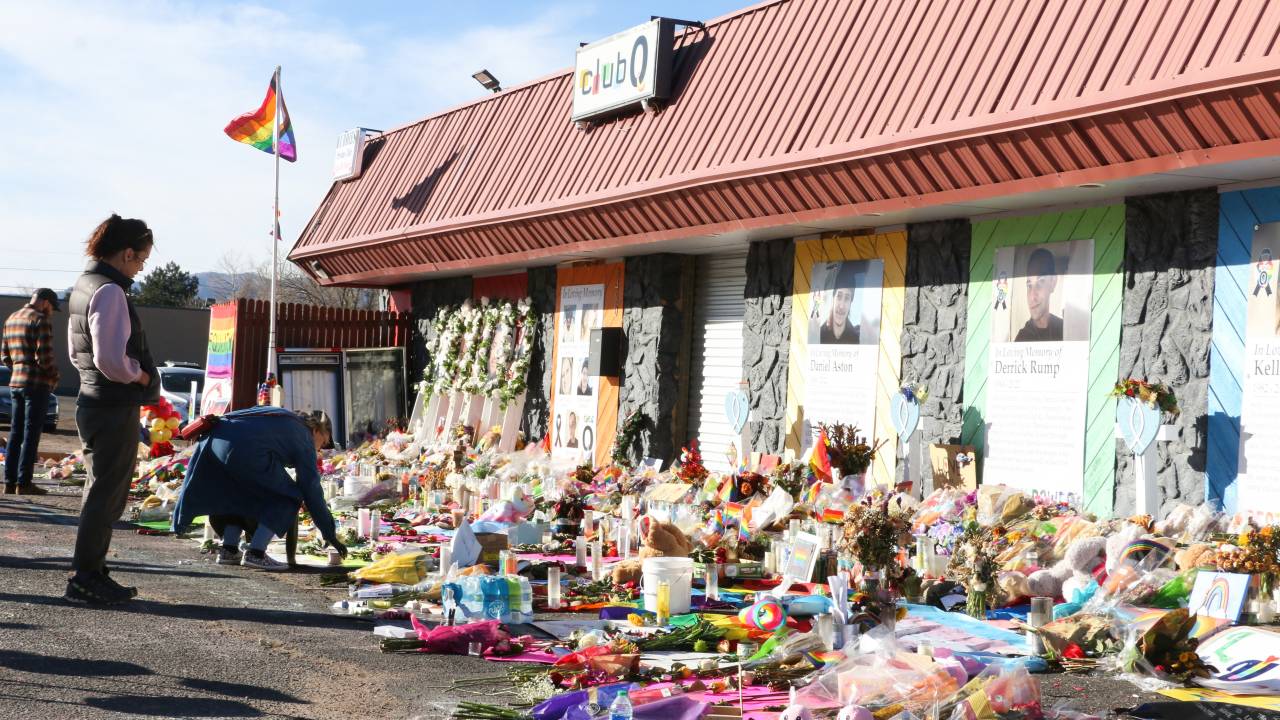 COLORADO SPRINGS, UNITED STATES - 2022/11/26: Mourners take photos and place flowers at the Club Q memorial. The Club Q shooting memorial continues growing one week after a mass shooter took five lives and injured 18 others on Nov. 19 at an LGBTQ club in Colorado Springs. (Photo by Brett Forrest/SOPA Images/LightRocket via Getty Images)
