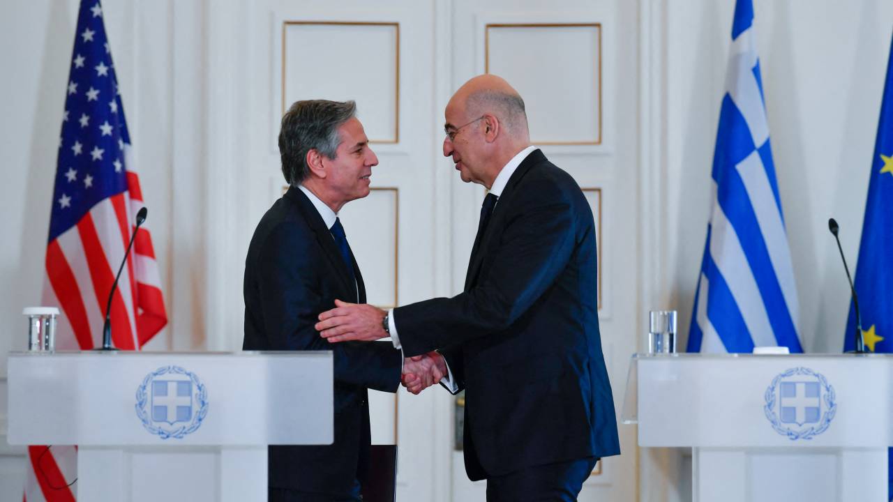 Greeces Foreign Affairs Minister Nikos Dendias (R) and US Secretary of State Antony Blinken, (L), shake hands during a press conference in Athens, on February 21, 2023. - Antony Blinken is on a two-day trip in Athens, following a trip to Turkey, for discussions on US-Greece Strategic Dialogue. (Photo by Michael Varaklas / POOL / AFP)