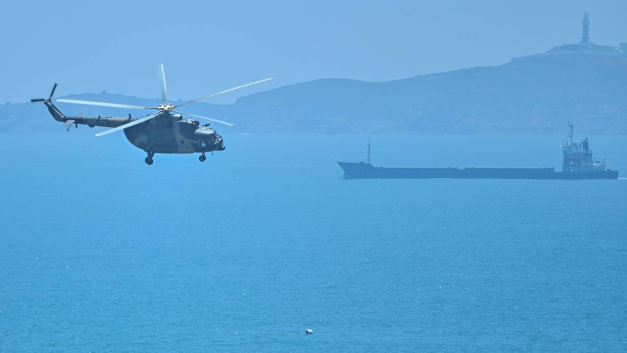 (FILES) This file photo taken on August 4, 2022 shows a Chinese military helicopter flying past Pingtan island, one of mainland China's closest point from Taiwan, in Fujian province on August 4, 2022, ahead of massive military drills off Taiwan following US House Speaker Nancy Pelosi's visit to the self-ruled island. - China on March 5, 2023 said it would raise its defence spending by 7.2 percent in 2023, compared with 7.1 percent last year, as its outgoing premier warned of growing "external" threats to Beijing's rise. (Photo by Hector RETAMAL / AFP)