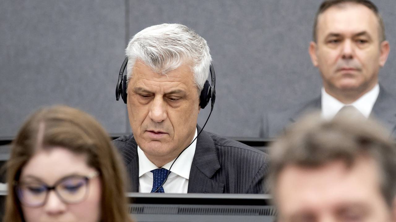 Former Kosovo president Hashim Thaci (L) sits in court, near former KLA figure Rexhep Selimi (rear), as he appears on charges of war crimes before the Kosovo Tribunal in The Hague on April 3, 2023. - Former Kosovo president Hashim Thaci goes on trial at a Hague war crimes tribunal on April 3, accused of a bloody campaign of murder and torture in the 1998-1999 independence war with Serbia. The one-time guerrilla hero, who denies the charges, allegedly targeted perceived enemies of the ethnic Albanian Kosovo Liberation Army (KLA), including Serbs and Roma, as the rebels sought to seize power. (Photo by Koen van Weel / ANP / AFP) / Netherlands OUT