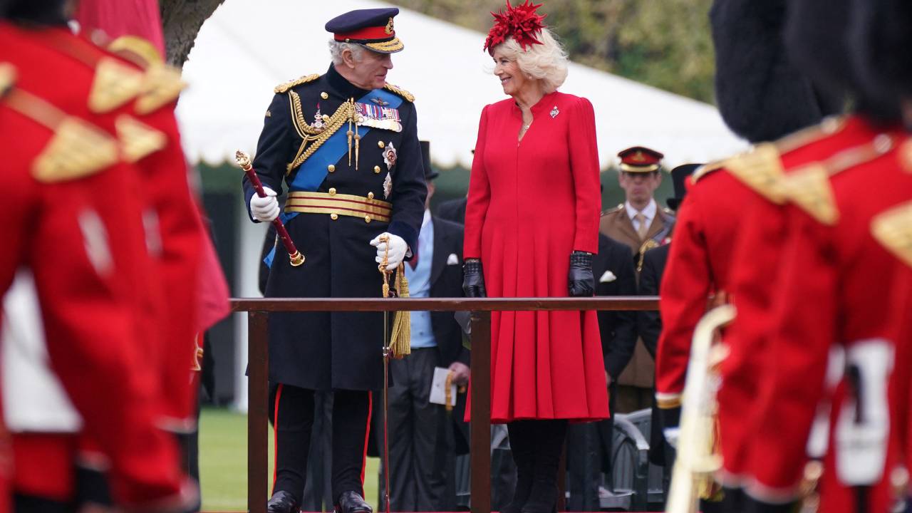 Britain's King Charles III (L) and Britain's Camilla, Queen Consort (R) attend a ceremony to present the new standards and colours to the Royal Navy, the Life Guards of the Household Cavalry Mounted Regiment, The Kings Company of the Grenadier Guards and The Kings Colour Squadron of the Royal Air Force at Buckingham Palace, in London, on April 27, 2023. (Photo by Yui Mok / POOL / AFP)