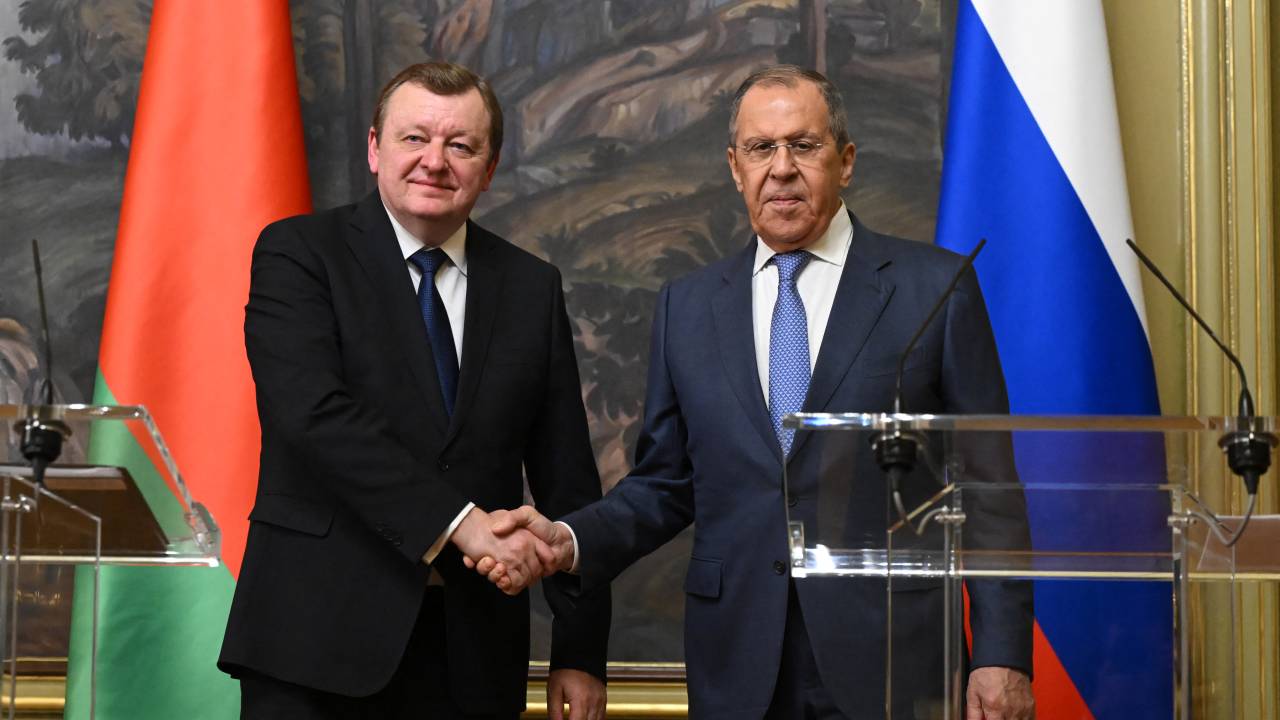 Russian Foreign Minister Sergei Lavrov and his Belarusian counterpart Sergei Aleinik shake hands during a joint press conference following their talks in Moscow on May 17, 2023. (Photo by NATALIA KOLESNIKOVA / POOL / AFP)