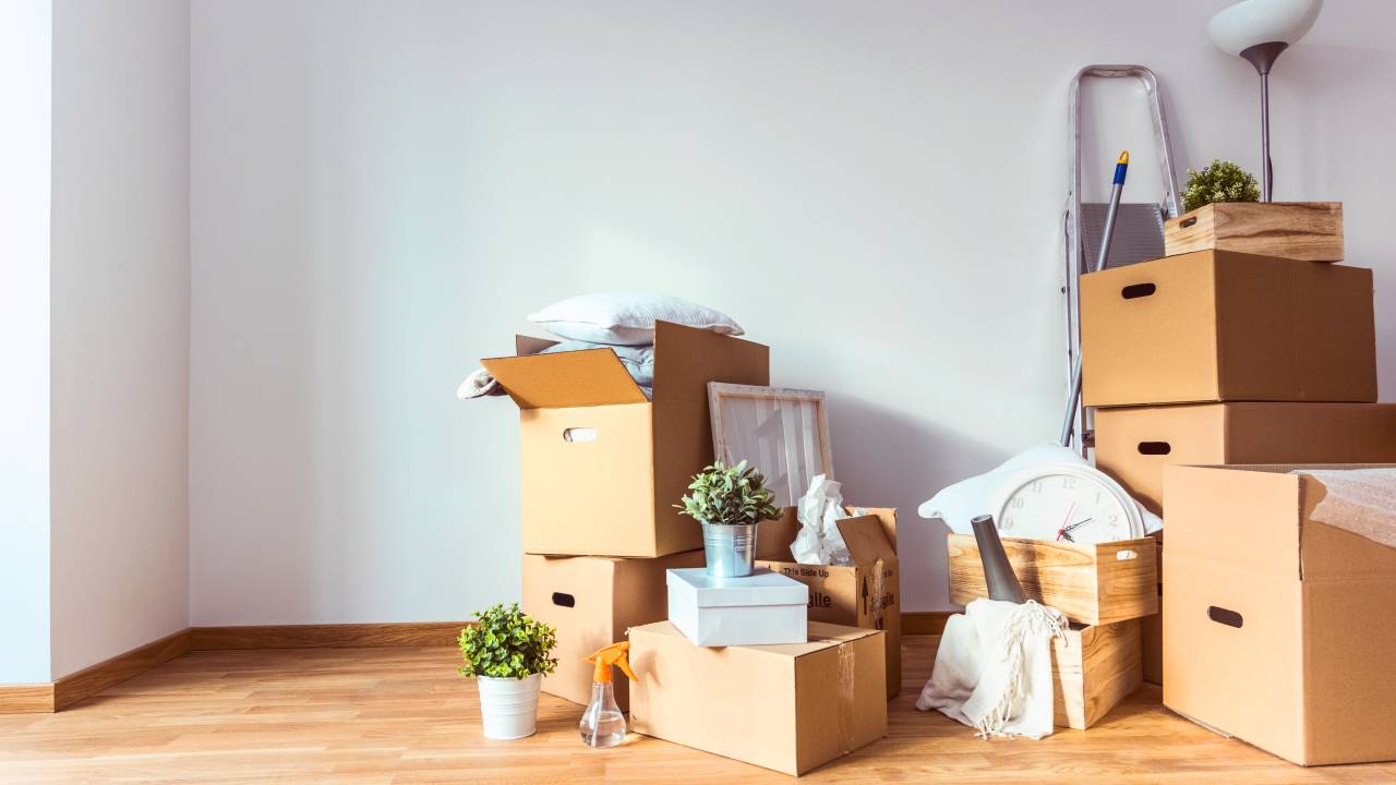 Empty room full of cardboard boxes and cleaning things for moving into a new home