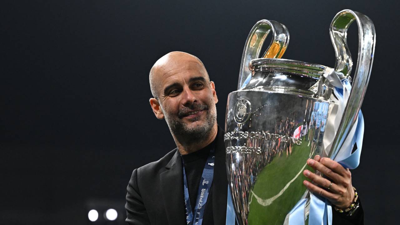 Manchester City's Spanish manager Pep Guardiola poses with the European Cup trophy as they celebrate winning the UEFA Champions League final football match between Inter Milan and Manchester City at the Ataturk Olympic Stadium in Istanbul, on June 10, 2023. Manchester City won the match 1-0. (Photo by Paul ELLIS / AFP)