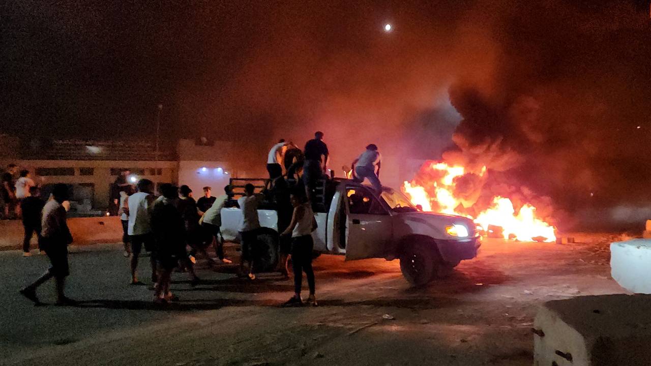 Libyans burn tyres as they protest in Tripoli on August 28, 2023, following an informal meeting between the country's foreign minister and her Israeli counterpart. The leader of Libya's government said that he had suspended his foreign minister after her Israeli counterpart announced he had held talks with her last week in Rome. (Photo by Mahmud TURKIA / AFP)