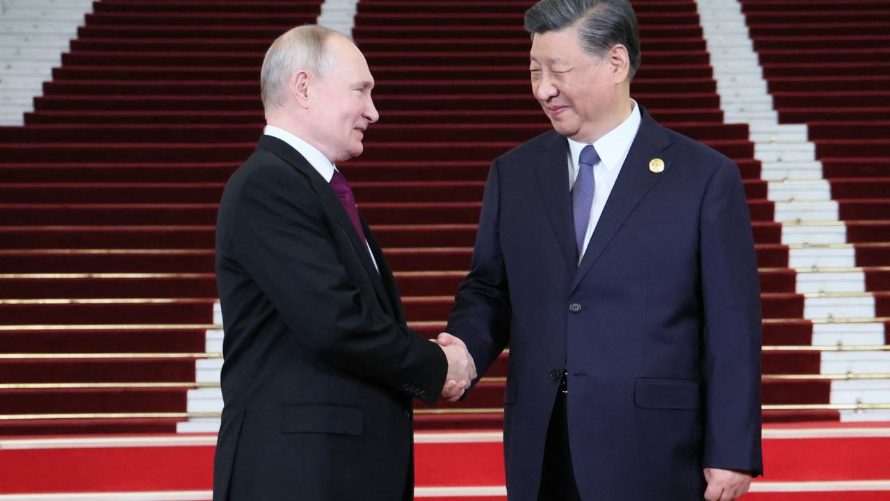 This pool photograph distributed by Russian state owned agency Sputnik shows Russia's President Vladimir Putin and Chinese President Xi Jinping shaking hands during a welcoming ceremony at the Third Belt and Road Forum in Beijing on October 17, 2023. (Photo by Sergei SAVOSTYANOV / POOL / AFP)