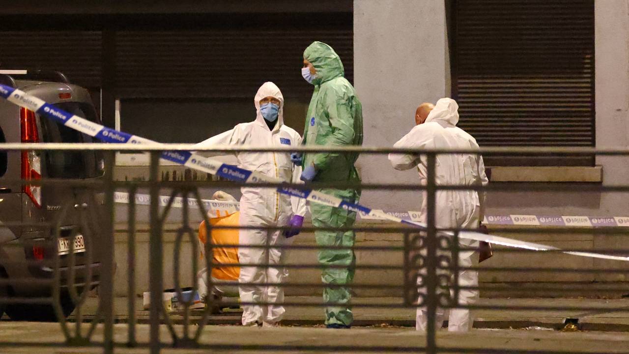 Belgian police officers from the forensic service search for evidence in a street after two people were killed during a shooting in Brussels on October 16, 2023 evening by a suspect who is on the run, the Belgian capital's prosecutor's office said. The alleged gunman in a fluorescent orange jacket fled the scene after using an automatic rifle, according to a video shared by Flemish newspaper Het Laatste Nieuws. A spokeswoman for the prosecutor's office said an investigation had been opened but did not speculate on the gunman's motive. (Photo by Kenzo TRIBOUILLARD / AFP)