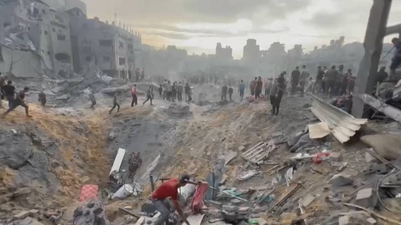 This image grab taken from AFPTV video footage shows Palestinians looking for survivors in a crater following a stike on a refugee camp in Jabalia on the northern Gaza Strip, on October 31, 2023, amid relentless Israeli bombardment of the Palestinian territory. The health ministry in the Hamas-run Gaza Strip said at least 50 people were killed on October 31 in Israeli bombardment of the refugee camp in the Palestinian territory.