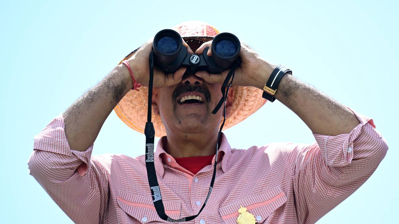 Venezuelan President and presidential candidate Nicolas Maduro looks through binoculars during his campaign closing rally in Maracaibo, Zulia State, Venezuela, on July 25, 2024, ahead of Sunday's presidential election. Venezuelan President Nicolas Maduro and his main rival in the July 28 presidential elections, opposition candidate Edmundo Gonzalez Urrutia, close their campaigns on Thursday amidst Maduro's warnings of a "bloodbath" or a military insurrection if he is defeated. (Photo by Raul ARBOLEDA / AFP)